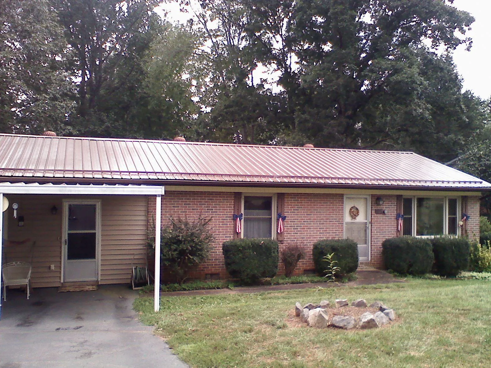 Bronze metal roof and carport on a brick ranch home — Roof Repair work by our crew in Warrenville